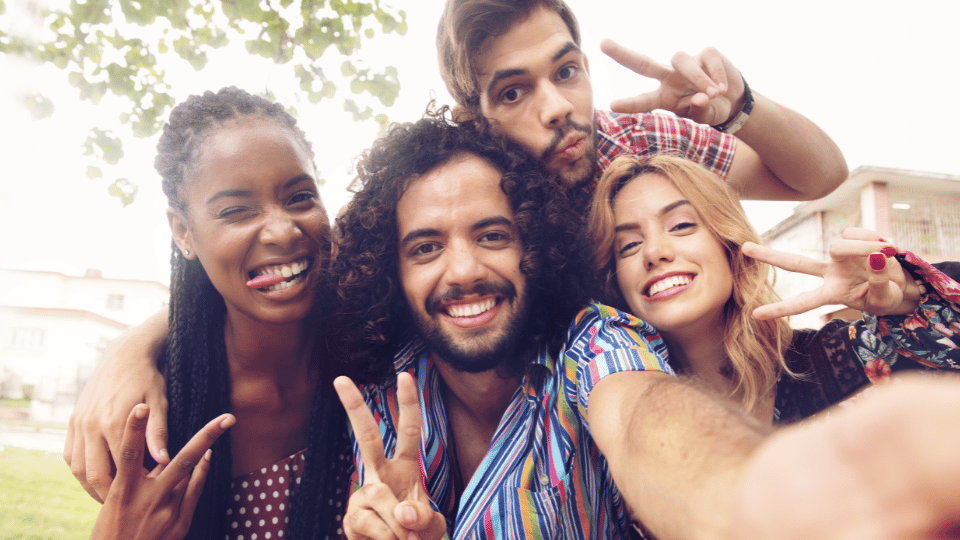 A group of diverse friends happily posing for a selfie, symbolizing the community support and opportunities provided by grants and CDFIs for Hispanic entrepreneurs.