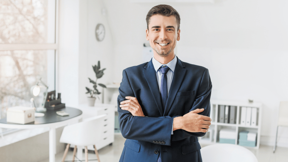 Smiling businessman in a suit representing traditional banks that offer business loans for small businesses in Puerto Rico.